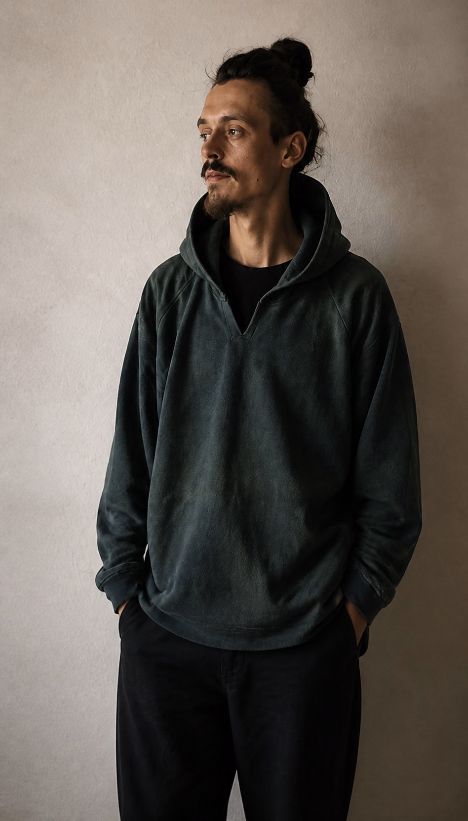 Man wearing a forest green hemp hoodie