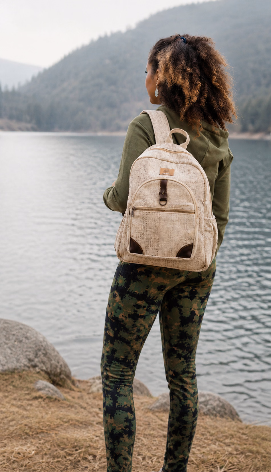 Woman carrying a natural hemp backpack beside a mountain lake