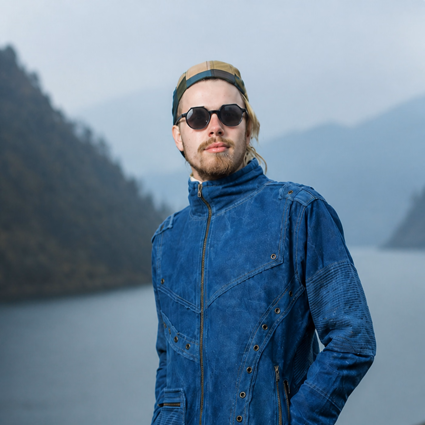 Blue hemp denim jacket styled beside a mountain lake